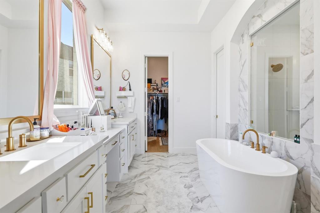 16194 Inca Dove Court Frisco, TX 75035 - Photo 17 of 40 Primary Bathroom featuring a enclosed tiled shower, freestanding tub and extended quartz vanities with make up area.