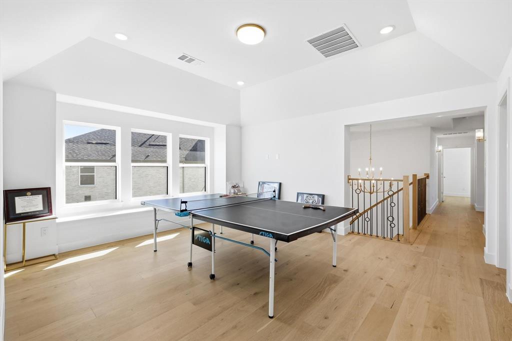 16194 Inca Dove Court Frisco, TX 75035 - Photo 27 of 40 Game Room featuring abundant natural light, recessed lighting, tall ceiling, upgraded wood floors and visual access to both the Foyer and Family Room below.
