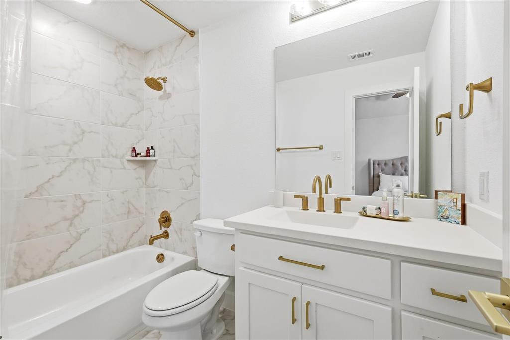 16194 Inca Dove Court Frisco, TX 75035 - Photo 33 of 40 Bath 4 featuring shower / bathtub combination and vanity with gold hardware.