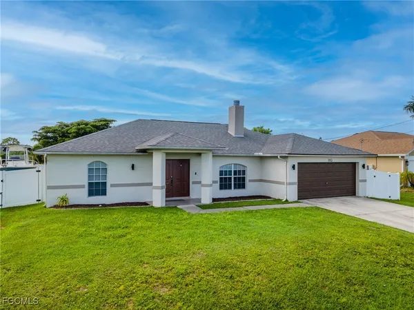 a front view of house with yard and green space