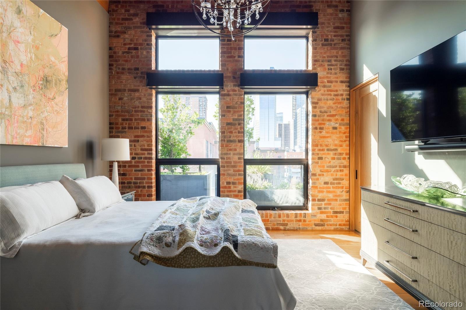 1500 Wynkoop Street, Unit PH1 Denver, CO 80202 - Photo 47 of 50 a bedroom with a large bed and a flat tv screen