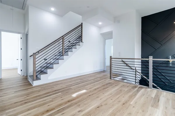 a view of entryway and hall with wooden floor