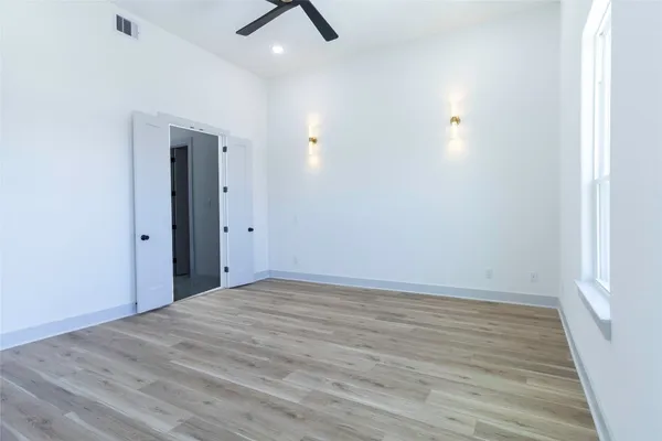 wooden floor in an empty room with a window
