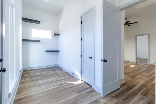 a view of a hallway with wooden floor