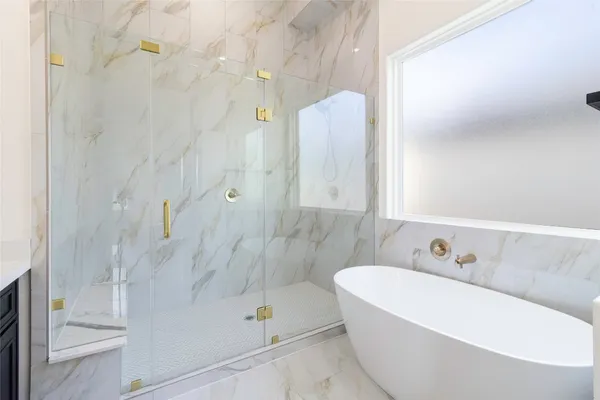 a bathroom with a bathtub and a shower
