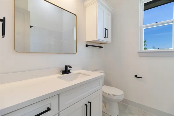 a bathroom with a sink a toilet and mirror