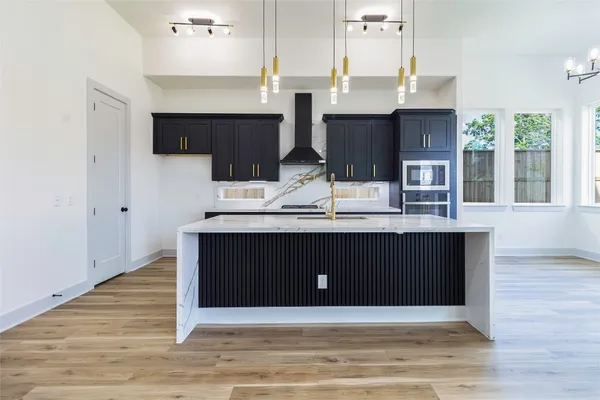 a kitchen with a cabinets and a wooden floor