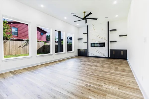 a view of a livingroom with furniture staircase and a ceiling fan