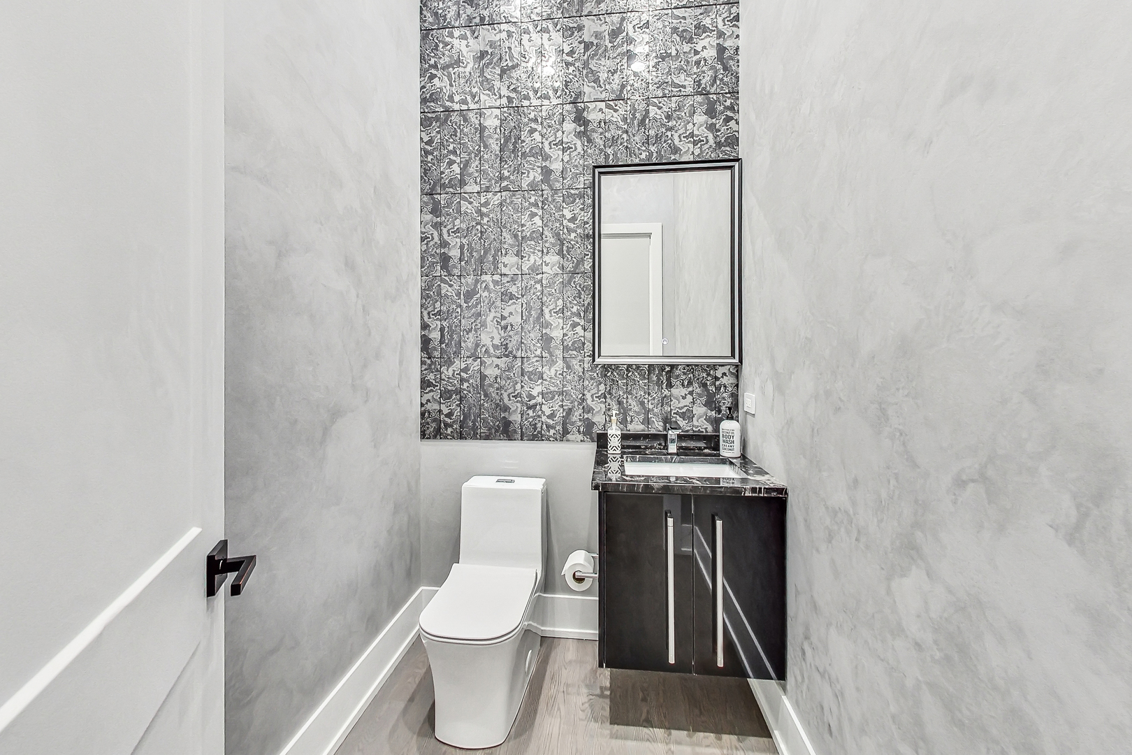 1331 Pfingsten Road Northbrook, IL 60062 - Photo 11 of 29 a bathroom with a toilet sink and mirror