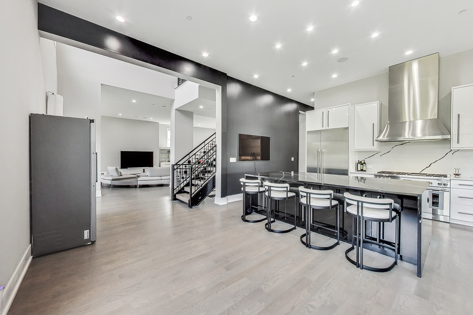 1331 Pfingsten Road Northbrook, IL 60062 - Photo 10 of 29 a large white kitchen with furniture and a flat screen tv