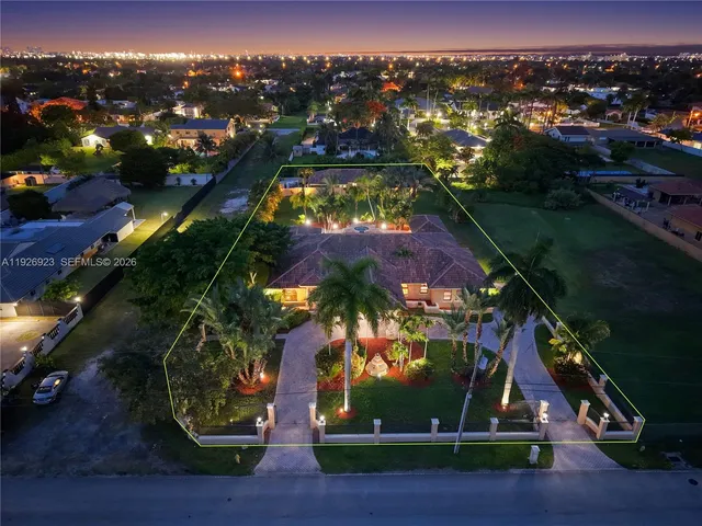 an aerial view of a house swimming pool outdoor seating and outdoor kitchen