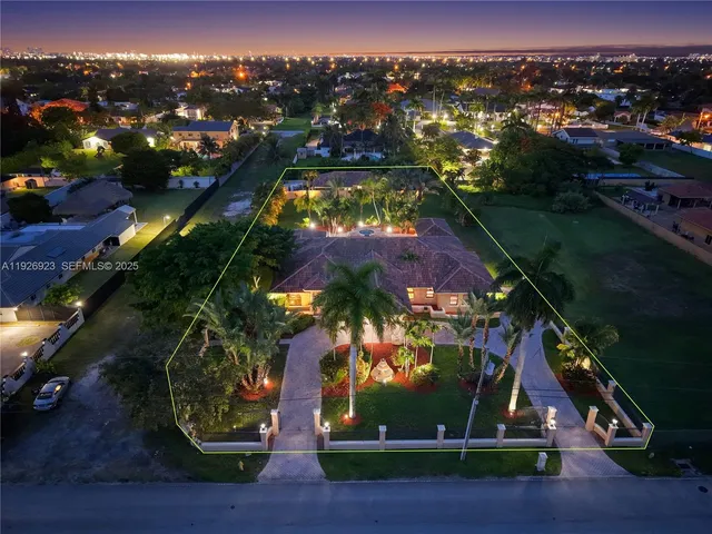 an aerial view of multiple houses with yard