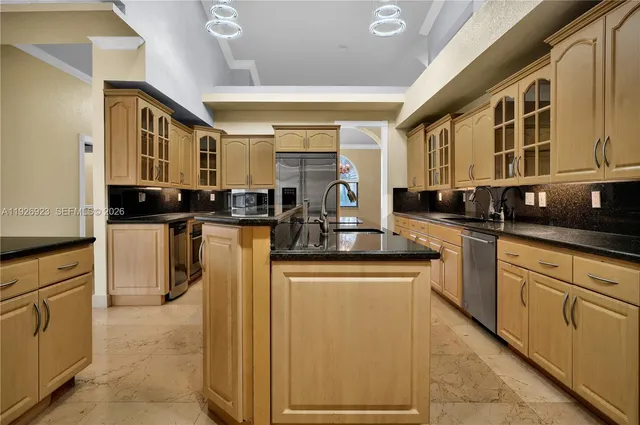 a spacious bathroom with a granite countertop sink toilet and shower