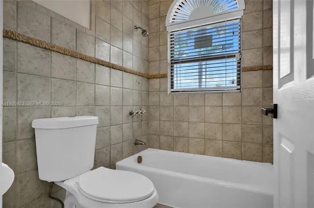 a bathroom with a shower a toilet and sink