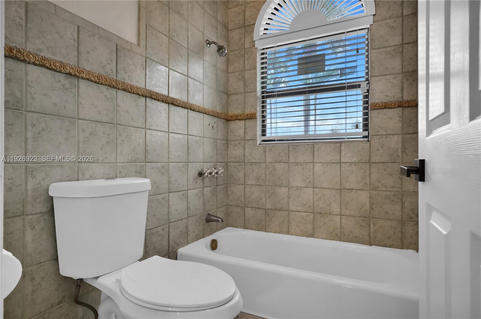 3001 Southwest 132nd Avenue Miami, FL 33175 - Photo 25 of 54 a white toilet and tub sitting next to a window