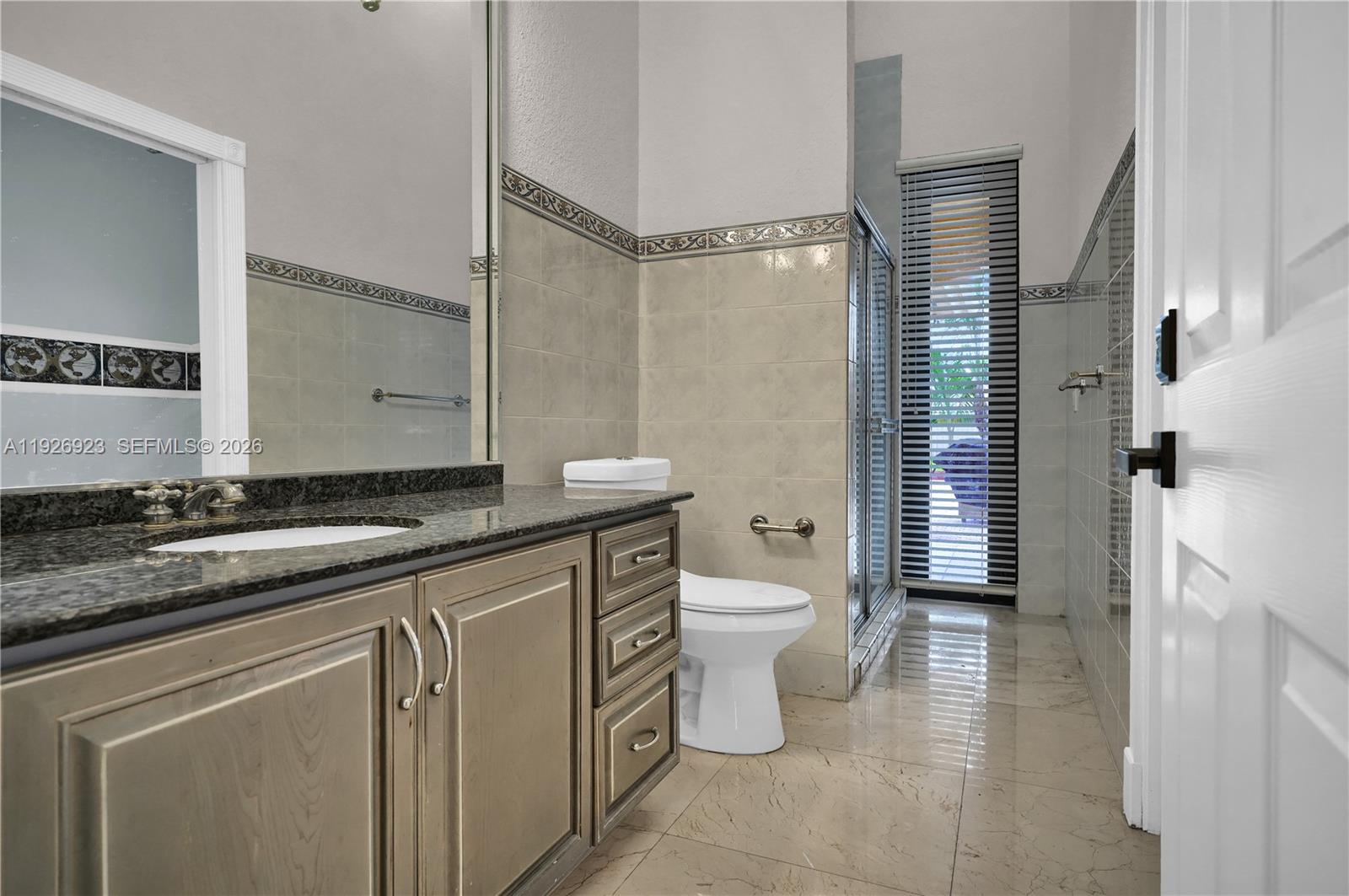 3001 Southwest 132nd Avenue Miami, FL 33175 - Photo 28 of 54 a spacious bathroom with a granite countertop sink toilet and shower