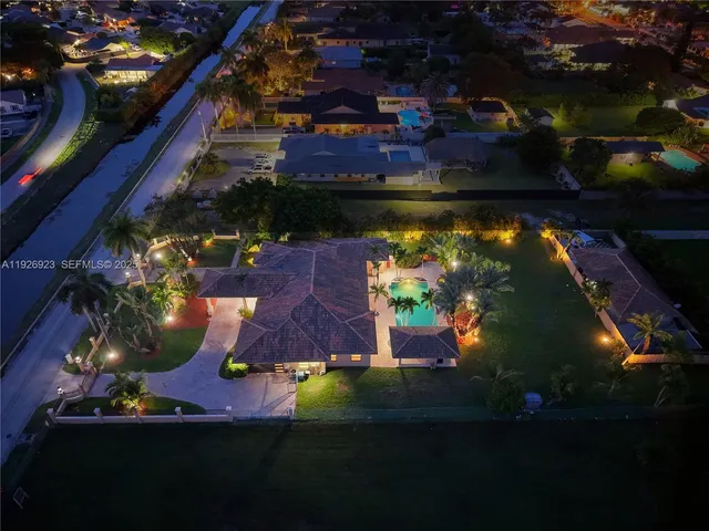 an aerial view of a house swimming pool outdoor seating and outdoor kitchen