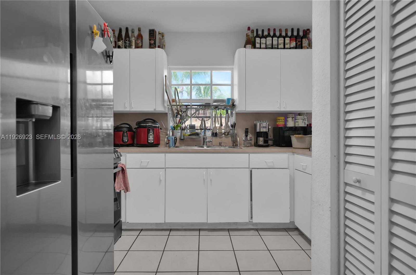 3001 Southwest 132nd Avenue Miami, FL 33175 - Photo 46 of 54 a kitchen with a refrigerator and cabinets