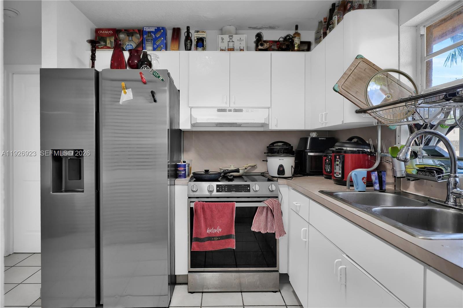 3001 Southwest 132nd Avenue Miami, FL 33175 - Photo 47 of 54 a kitchen with stainless steel appliances granite countertop a sink and a refrigerator