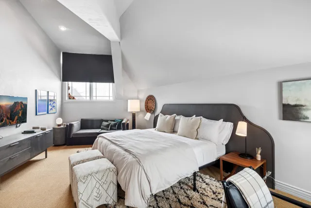 a bed room with a bed window and a television