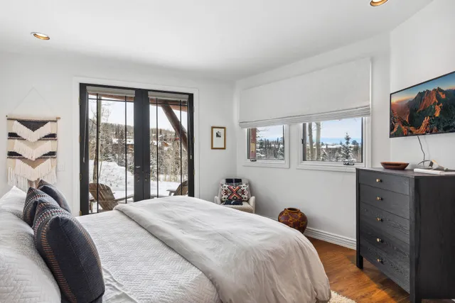 a bedroom with a bed and a flat screen tv