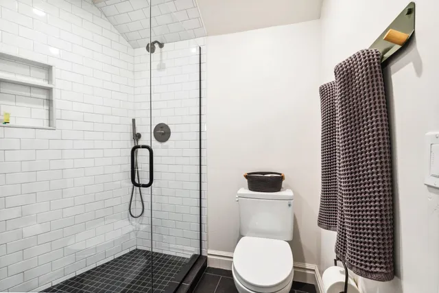 a bathroom with a toilet and a shower