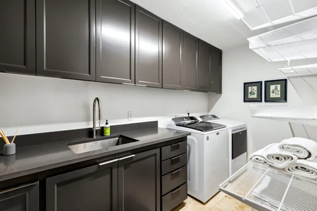 a kitchen with stainless steel appliances granite countertop a sink stove and cabinets