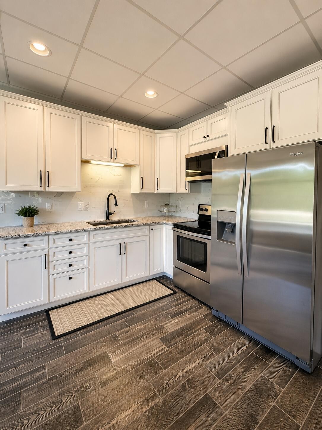 3870 Head Road Adams, TN 37010 - Photo 19 of 33 a kitchen with granite countertop a refrigerator sink and cabinets