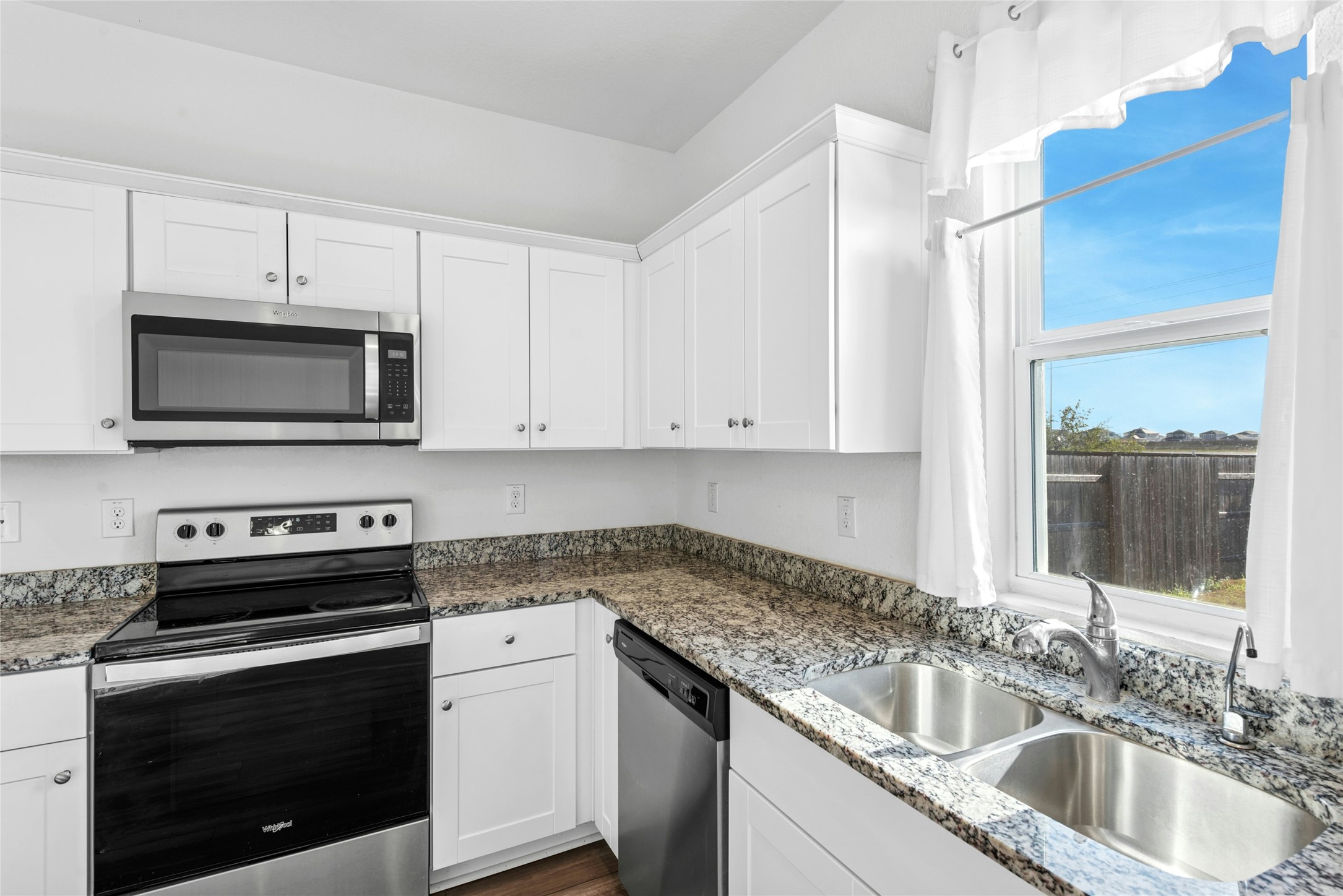 566 Delta Crest Maxwell, TX 78656 - Photo 9 of 27 Kitchen with appliances with stainless steel finishes, white cabinets, and dark stone countertops