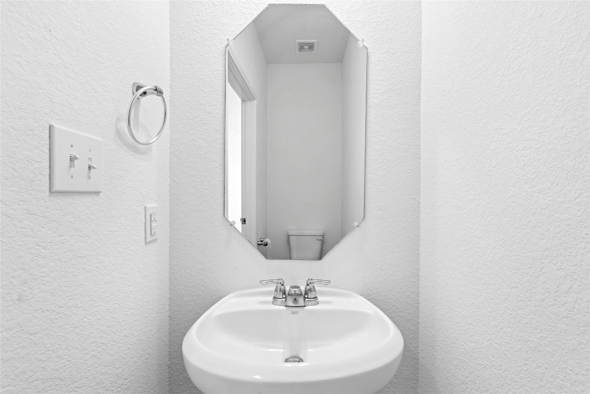 566 Delta Crest Maxwell, TX 78656 - Photo 11 of 27 a bathroom with a sink and a mirror