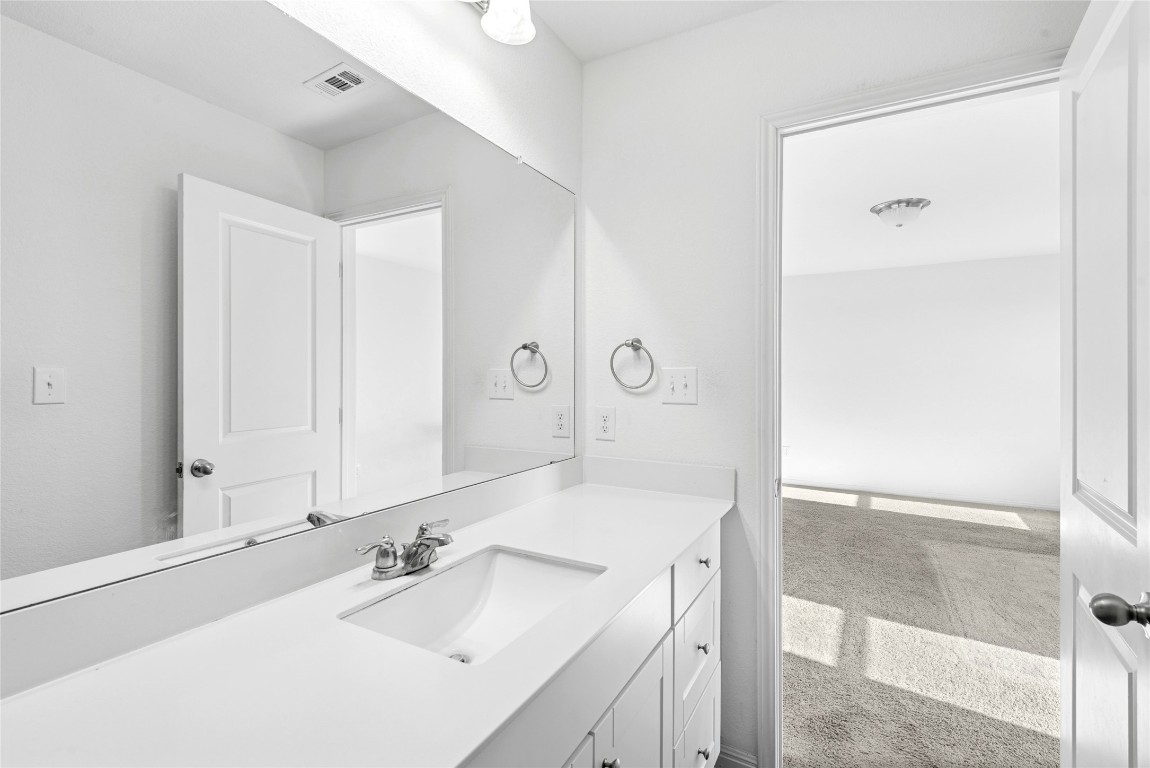 566 Delta Crest Maxwell, TX 78656 - Photo 15 of 27 a bathroom with a sink and a mirror