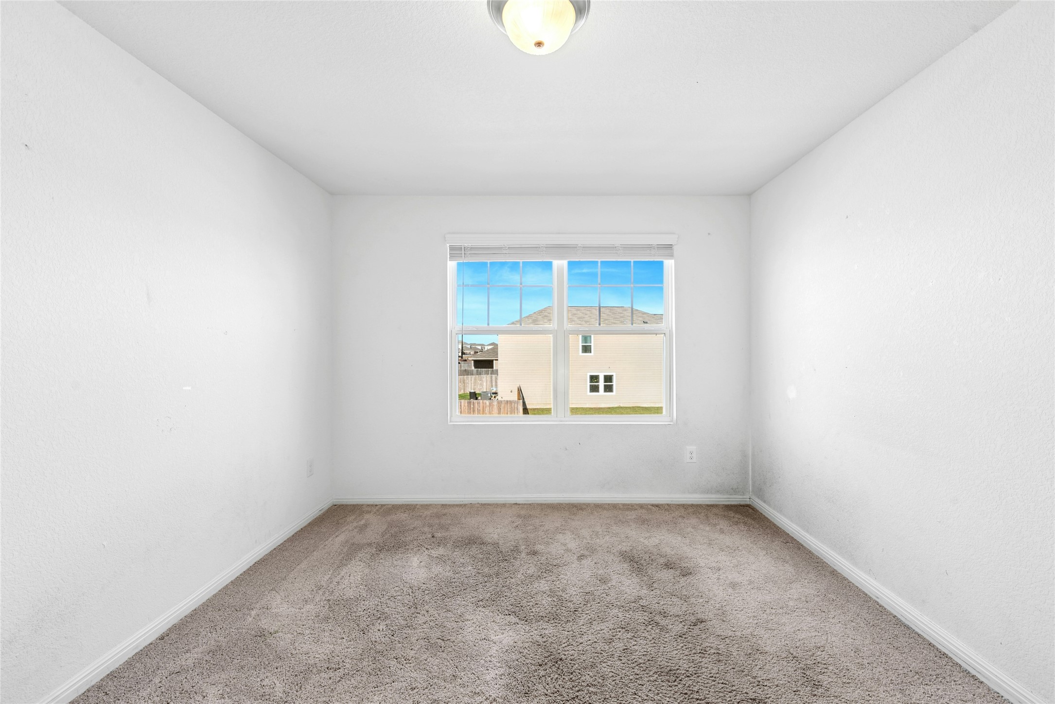 566 Delta Crest Maxwell, TX 78656 - Photo 18 of 27 Carpeted spare room featuring baseboards