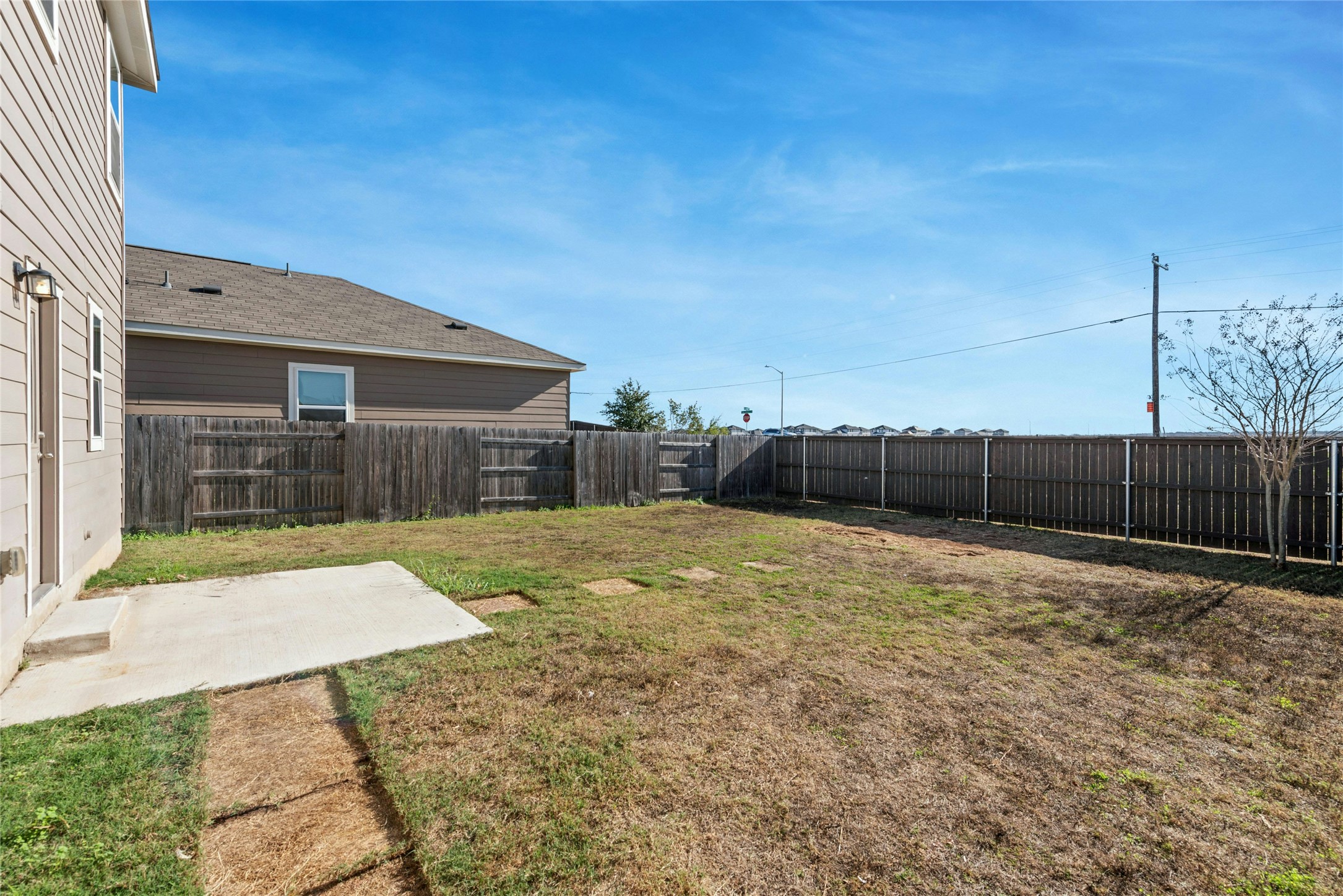 566 Delta Crest Maxwell, TX 78656 - Photo 21 of 27 Fenced backyard with a patio area