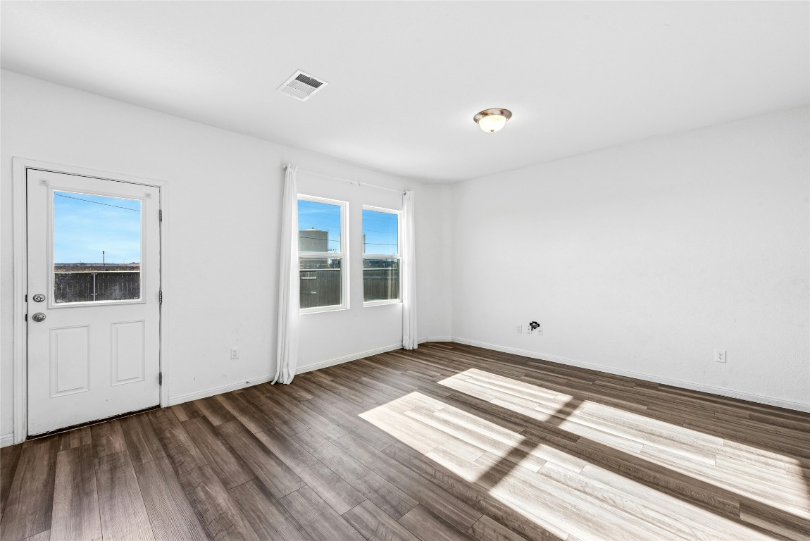 566 Delta Crest Maxwell, TX 78656 - Photo 6 of 27 a view of an empty room with wooden floor and a window