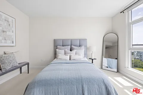 a bed room with a bed and a chair