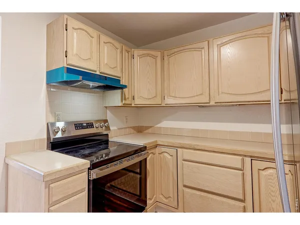 a kitchen with stainless steel appliances granite countertop a sink and cabinets