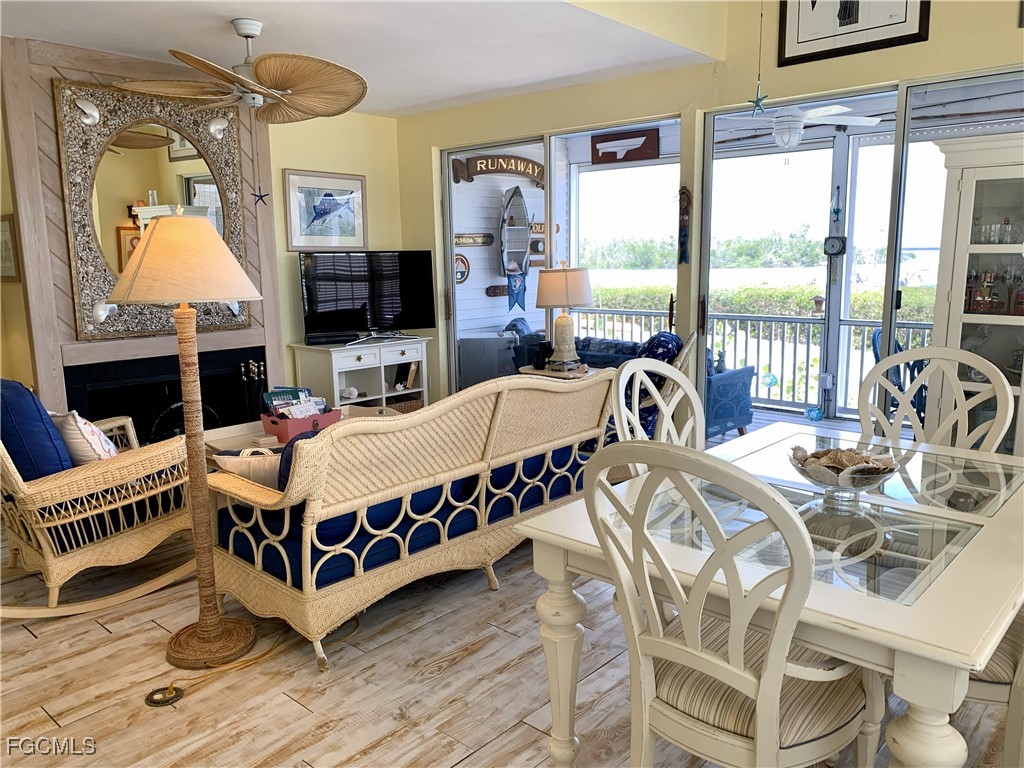 503 Useppa Useppa Island Bokeelia, FL 33922 - Photo 14 of 50 a living room with furniture a fireplace and a flat screen tv