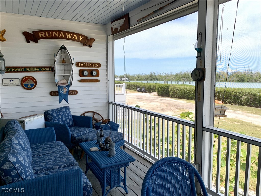 503 Useppa Useppa Island Bokeelia, FL 33922 - Photo 15 of 50 a view of living room with furniture and a floor to ceiling window