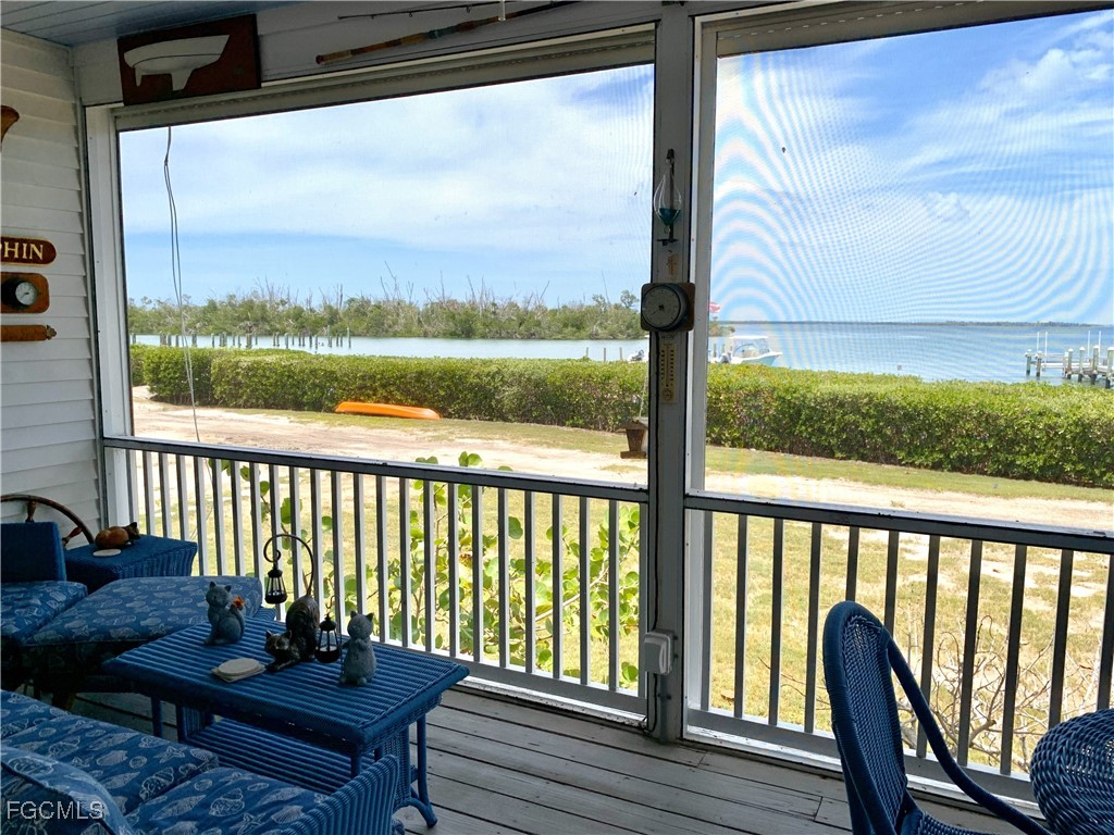 503 Useppa Useppa Island Bokeelia, FL 33922 - Photo 16 of 50 a view of a balcony with wooden floor