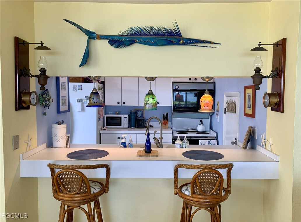 503 Useppa Useppa Island Bokeelia, FL 33922 - Photo 20 of 50 a kitchen with a sink a stove and a wooden cabinets