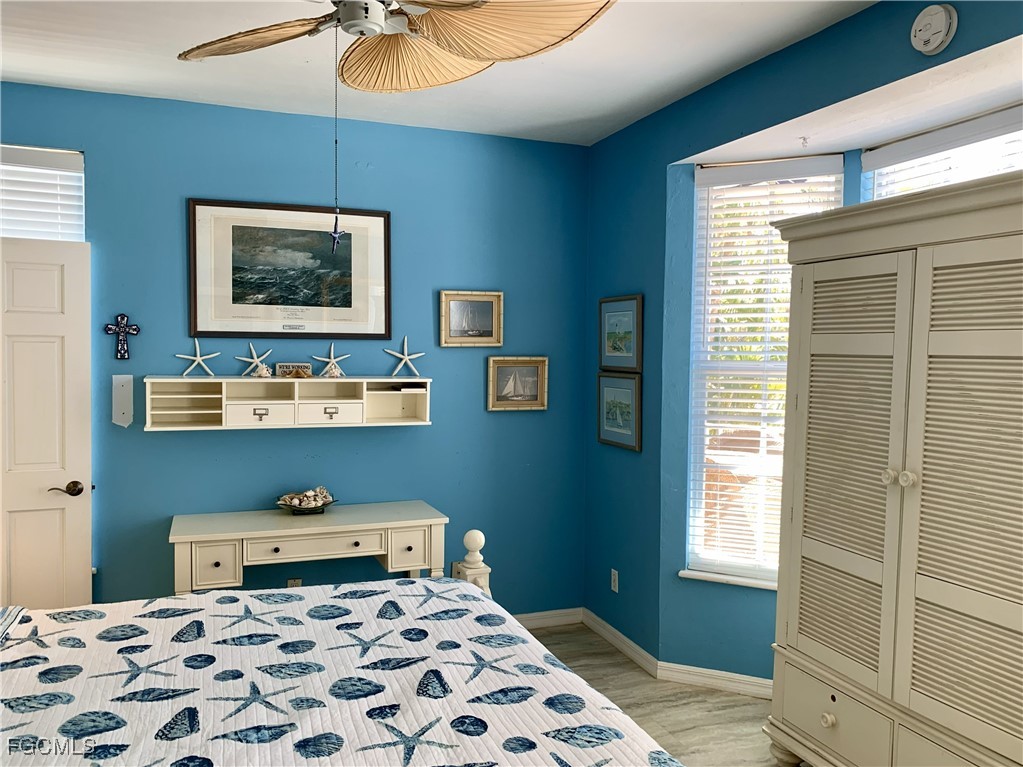 503 Useppa Useppa Island Bokeelia, FL 33922 - Photo 31 of 50 a bedroom with a bed and wooden floor