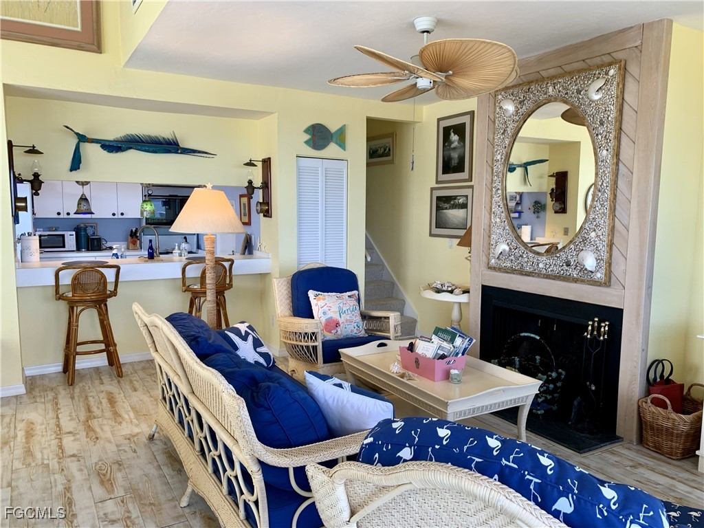 503 Useppa Useppa Island Bokeelia, FL 33922 - Photo 35 of 50 a living room with furniture a fireplace and a flat screen tv