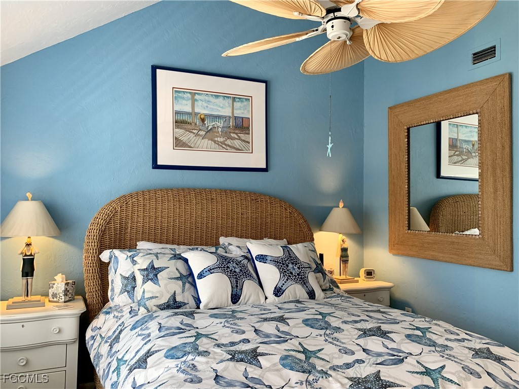 503 Useppa Useppa Island Bokeelia, FL 33922 - Photo 48 of 50 a bedroom with a bed and lamp