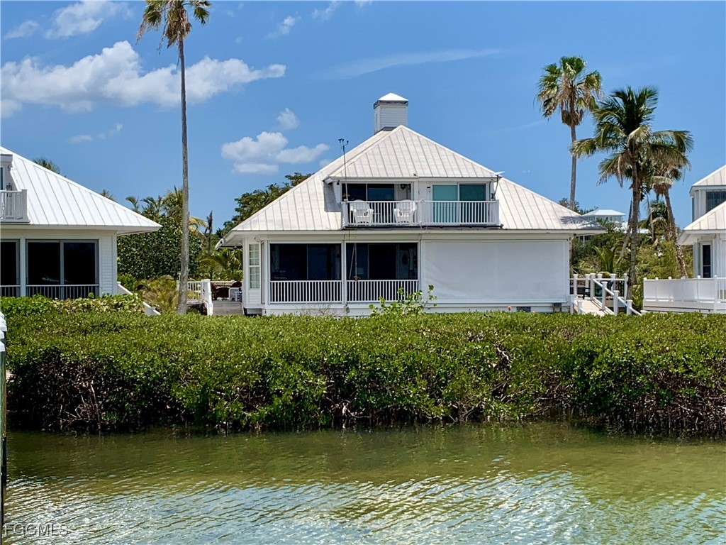 503 Useppa Useppa Island Bokeelia, FL 33922 - Photo 50 of 50 a front view of a house with a yard