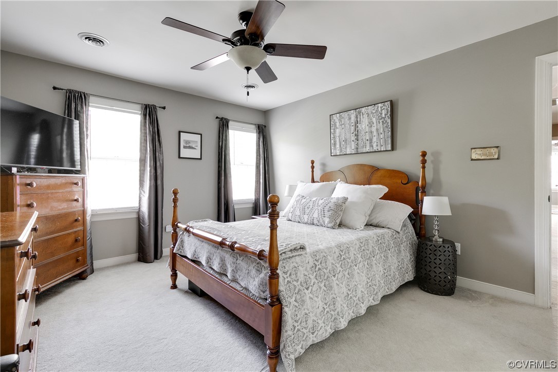 5709 Grove Forest Road Midlothian, VA 23112 - Photo 21 of 39 a bedroom with a bed and a flat tv screen on the dresser