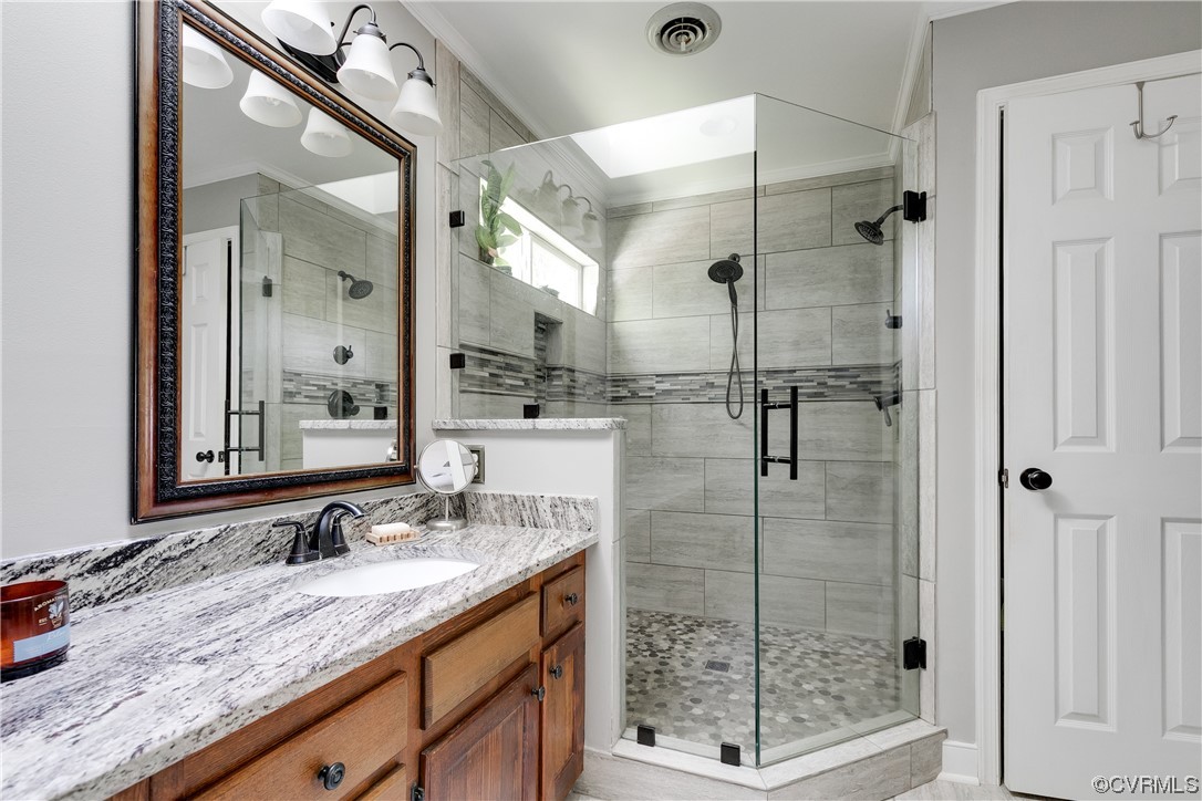 5709 Grove Forest Road Midlothian, VA 23112 - Photo 23 of 39 a bathroom with a shower sink and mirror
