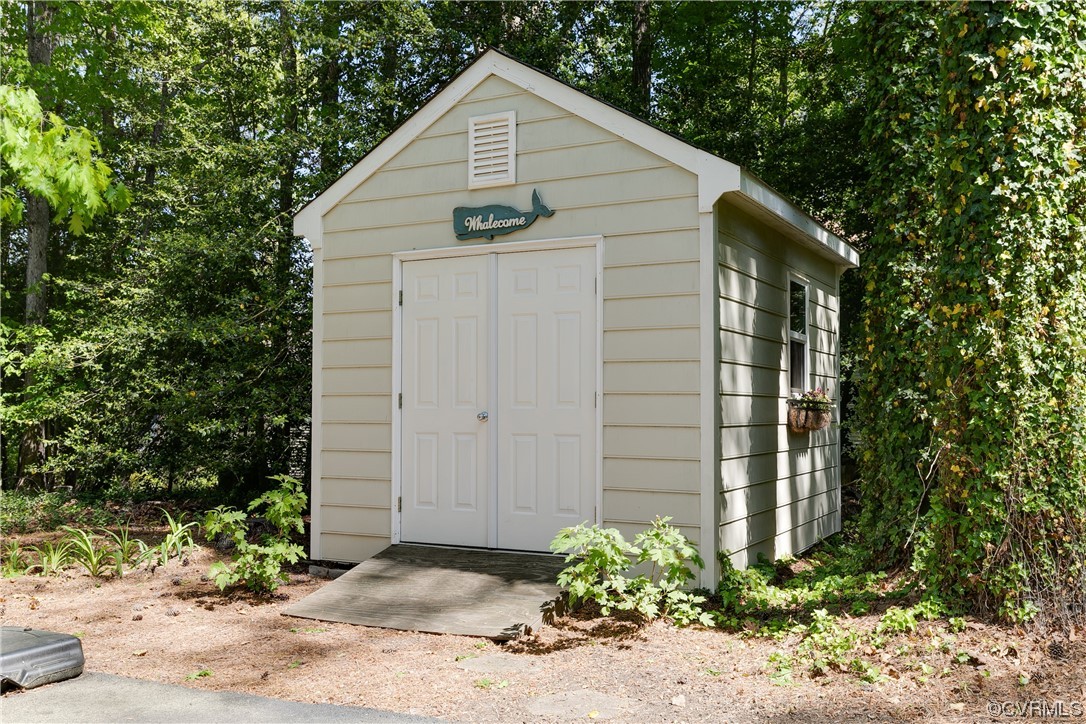 5709 Grove Forest Road Midlothian, VA 23112 - Photo 35 of 39 a view of a small house with plants and large trees