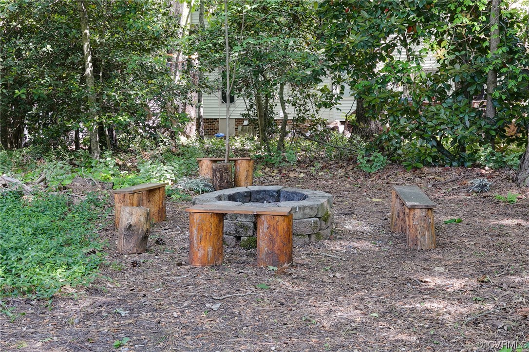 5709 Grove Forest Road Midlothian, VA 23112 - Photo 37 of 39 a view of a backyard with plants and outdoor seating
