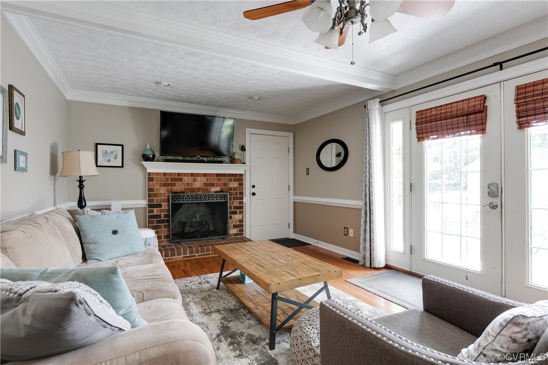 5709 Grove Forest Road Midlothian, VA 23112 - Photo 6 of 39 a living room with furniture a flat screen tv and a fireplace