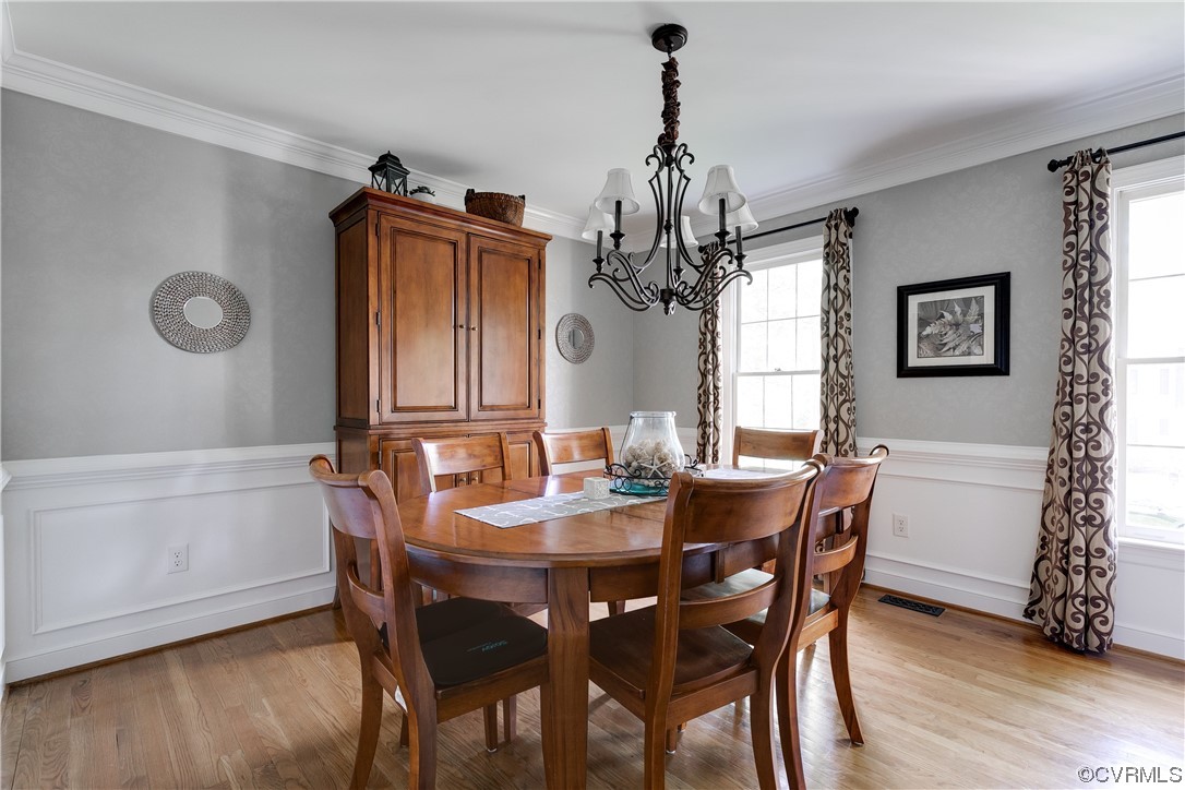 5709 Grove Forest Road Midlothian, VA 23112 - Photo 10 of 39 a view of a dining room with furniture window and wooden floor